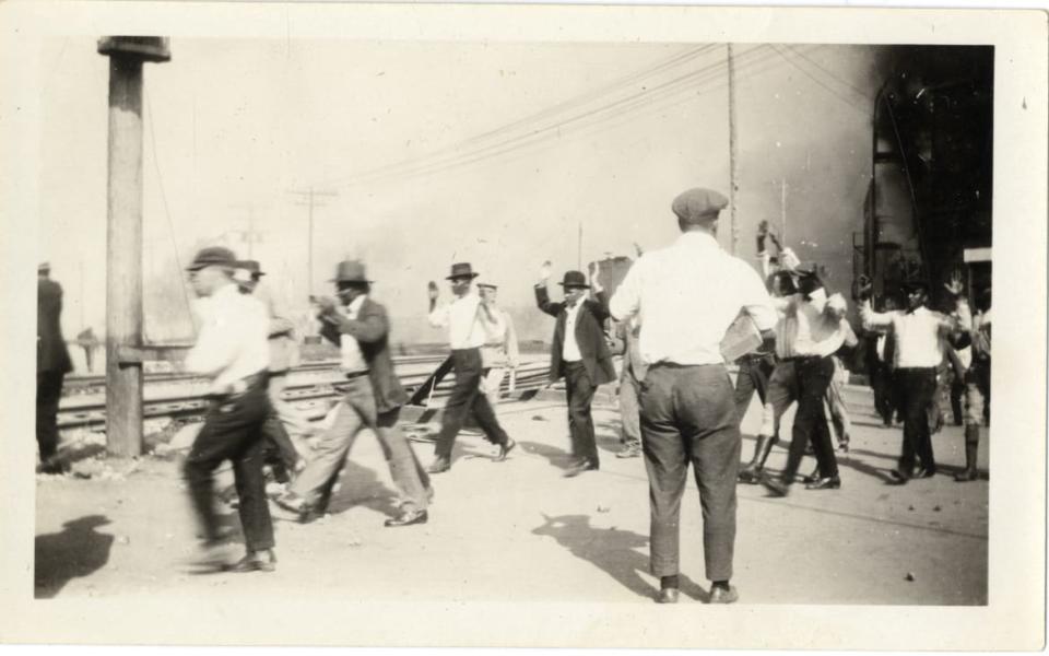 <div class="inline-image__caption"><p>Detainees being marched along the train tracks with their arms raised, during the Tulsa Race Massacre of 1921.</p></div> <div class="inline-image__credit">University of Tulsa, McFarlin Library</div>