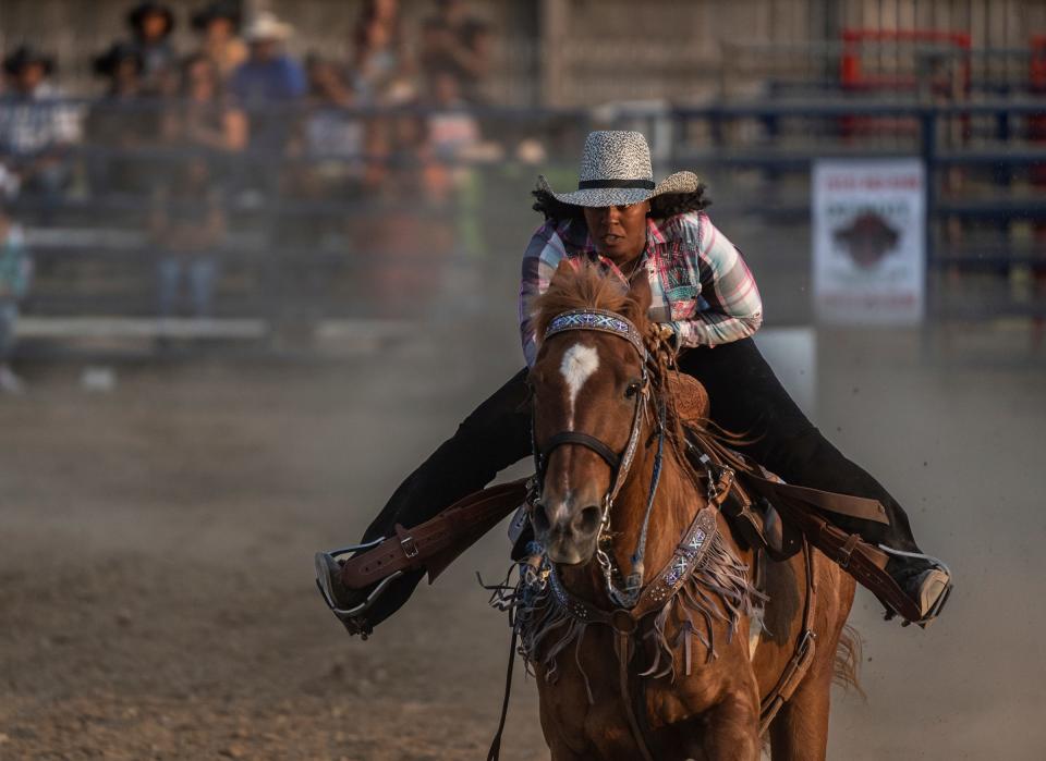Staci Russell, 39, of Belleville, and her horse, Reese's Cup, make their way to the finish line after circling their last barrel while competing in the barrel racing during the 2023 Midwest Invitational Rodeo at the Wayne County Fairgrounds in Belleville on Saturday, June 10, 2023. Russell finished in 16 seconds for first place for the second time during the two-day rodeo.