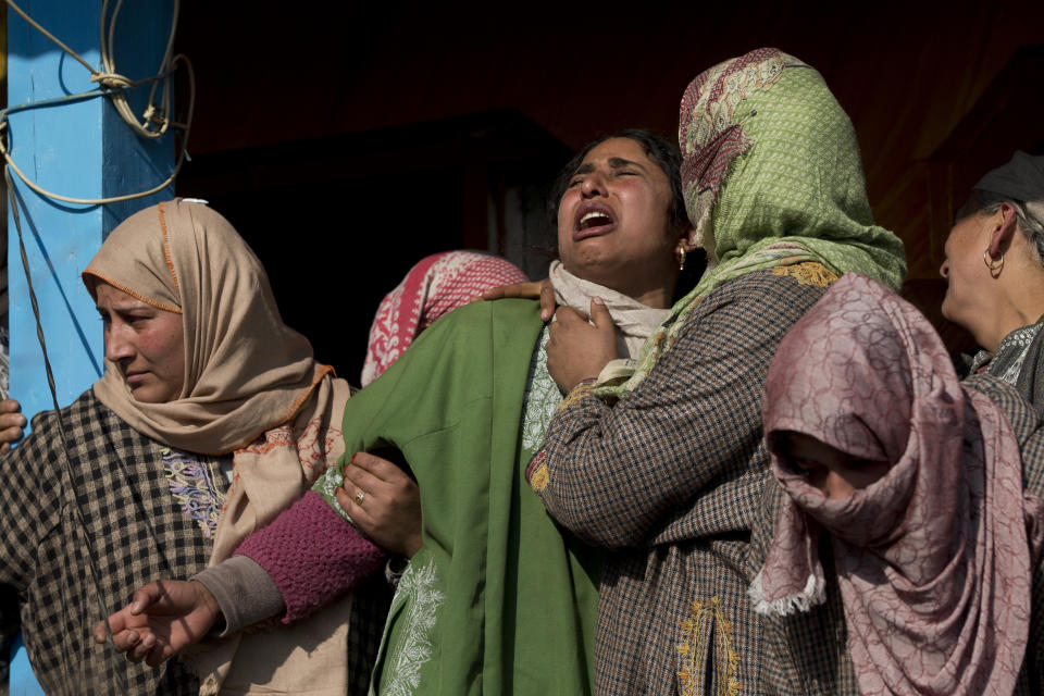 An unidentified relative of a local rebel Muzamil Ahmed Dar grieves during his funeral procession in Rahmoo village south of Srinagar, Indian controlled Kashmir, Saturday, Dec. 29, 2018. Anti-India protests and clashes erupted in disputed Kashmir on Saturday after a gunbattle between militants and government forces killed four rebels, police and residents said. (AP Photo/ Dar Yasin)