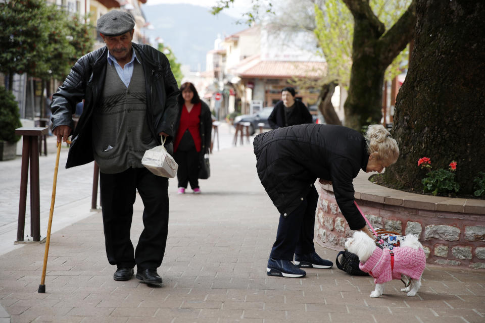 In this Tuesday, May 14, 2019, photo, a man uses his walking stick in Karpenisi town at Evrytania region, in central Greece. As balloting for the European Parliament gets underway Thursday and continues through Sunday voters over 55 are emerging as a powerful bloc on a rapidly aging continent as younger voters stay away from the polls in growing numbers. (AP Photo/Thanassis Stavrakis)