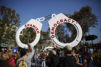 <p>Protesters hold fake handcuffs as they take part a rally outside the Catalan parliament in Barcelona, Spain, Friday, Oct. 27, 2017. Catalonia’s parliament on Friday will resume debating its response to the Spanish government’s plans to strip away its regional powers to halt it pushing toward independence. (Photo: Santi Palacios/AP) </p>