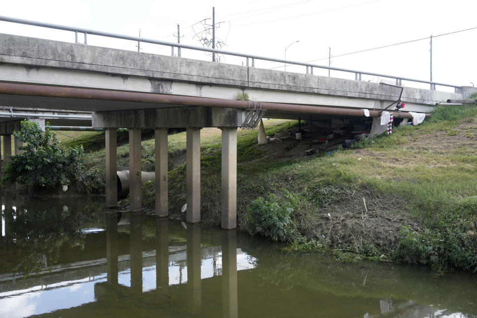 A bridge expands over a creek Tuesday, June 18, 2024, in Houston. Two men who were seen on surveillance footage with a 12-year-old girl hours before her body was found in a Houston creek earlier this week were arrested Thursday, June 20, 2024, in her death, police said. (Melissa Phillip/Houston Chronicle via AP)