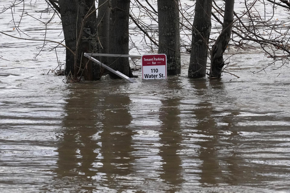 A sign is seen in the parking lot behind the Quarry Tap Room, Tuesday, Dec. 19, 2023, in Hallowell, Maine. Waters continue to rise in the Kennebec River following Monday's severe storm. (AP Photo/Robert F. Bukaty)