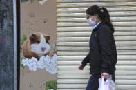 CORRECTS TO SAY 2,000 SMALL ANIMALS, NOT 2,000 HAMSTERS - A pet shop is closed after some pet hamsters were, authorities said, tested positive for the coronavirus, in Hong Kong, Tuesday, Jan. 18, 2022. Hong Kong authorities said Tuesday that they will kill about 2,000 small animals, including hamsters, after several tested positive for the coronavirus at the pet store where an employee was also infected. (AP Photo/Kin Cheung)