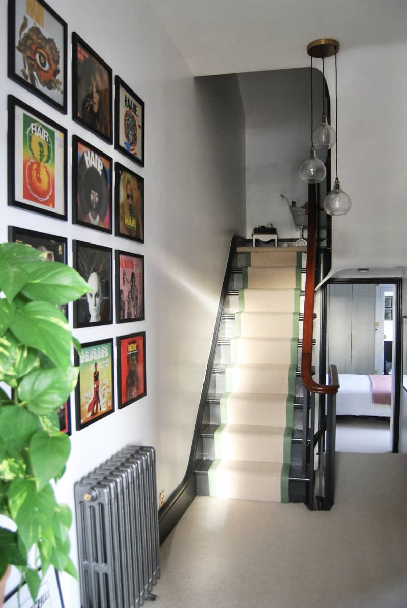 Stairway with a gallery wall of Hair covers.