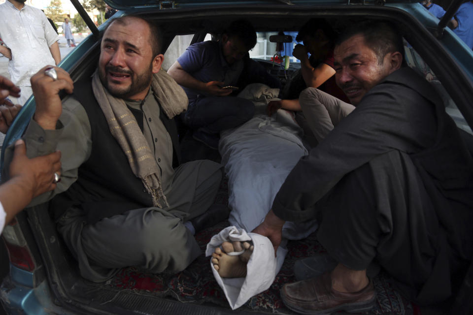 The body of a man killed in a deadly suicide bombing, that targeted a training class in a private building in the Shiite neighbourhood of Dasht-i Barcha, is taken for burial, in western Kabul, Afghanistan, Wednesday, Aug. 15, 2018. Both the resurgent Taliban and an Islamic State affiliate in Afghanistan have targeted Shiites in the past, considering them to be heretics. (AP Photo/Rahmat Gul)