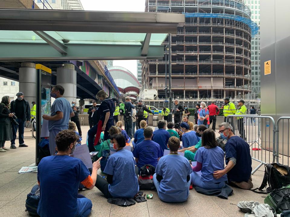 Protesters seen outside a DLR station in east London (The Independent)