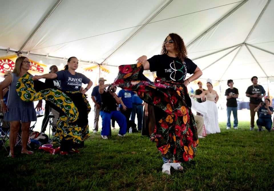 Audience members dance along as the 813 Project play Bomba, a music and dance style originating from enslaved Africans in Puerto Rico, during the Farmworker Freedom Festival at Bradley Park on Saturday.