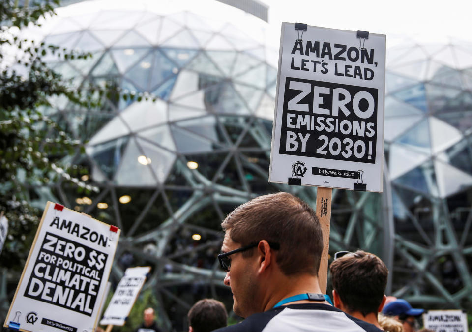 An attendee holds a sign asking Amazon to reach zero emissions by 2030 outside the Amazon Spheres during a Climate Strike walkout and march in Seattle, Washington, U.S. September 20, 2019. REUTERS/Lindsey Wasson     TPX IMAGES OF THE DAY