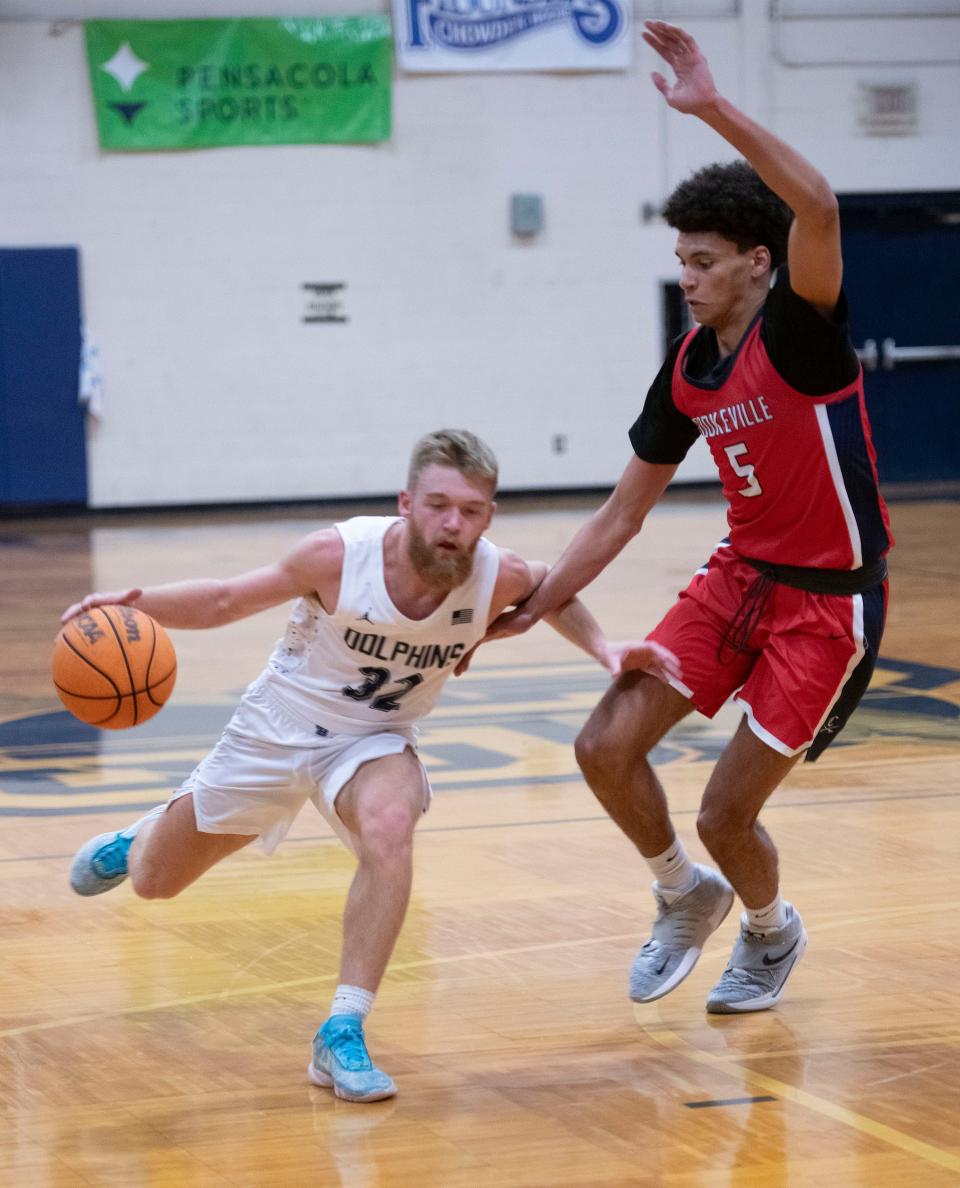 Gulf Breeze High School's Trent Peak (No. 32) drives the ball down court as Cookeville High School's Joshua Heard (No. 5) puts up a defense during the final days of the Innisfree Hotel Beach Basketball Tournament on Friday, Dec. 29, 2023.