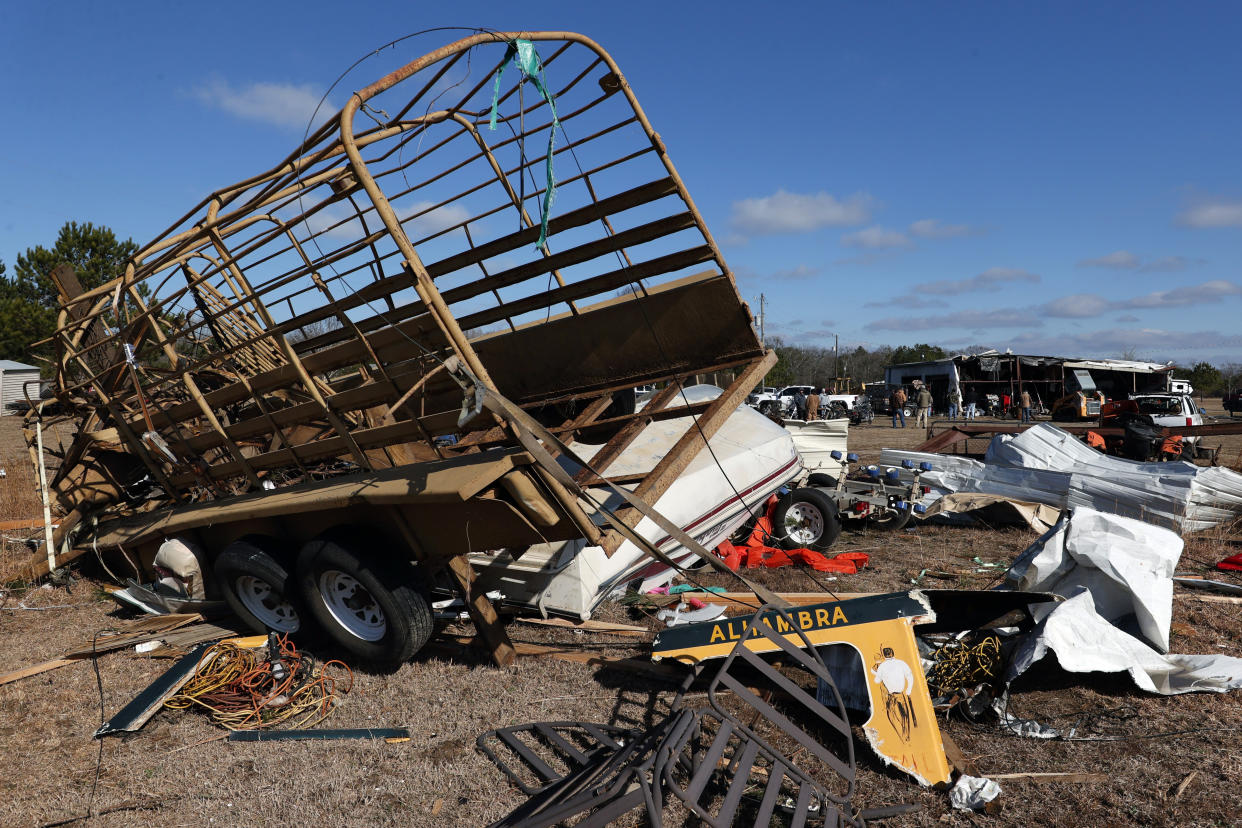 Debris stretches across a field after a tornado that ripped through Central Alabama earlier this week along County Road 140 where loss of life occurred Saturday, Jan. 14, 2023, in White City, Autauga County, Ala. (AP Photo/Butch Dill)