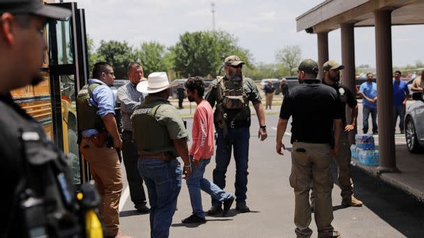 PHOTO: Children get on a school bus as law enforcement personnel guard the scene of a suspected shooting near Robb Elementary School in Uvalde, Texas, May 24, 2022. (Marco Bello/Reuters)