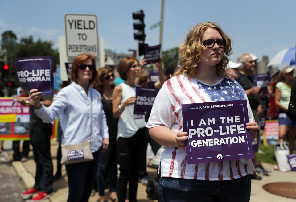 Anti-abortion advocates gather outside the Planned Parenthood clinic Tuesday, June 4, 2019, in St. Louis. A judge is considering whether the clinic, Missouri's only abortion provider, can remain open. (AP Photo/Jeff Roberson)