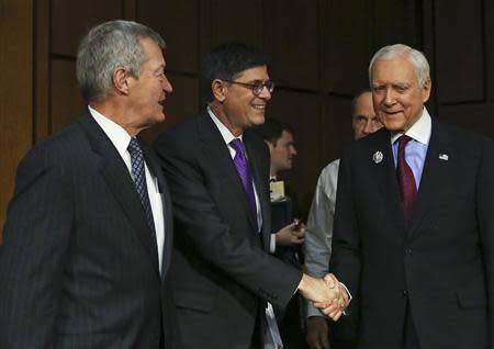 U.S. Treasury Secretary Jack Lew (C) is welcomed by Senators Max Baucus (D-MT) (L) and Orrin Hatch (R-UT) (R) before testifying at the Senate Finance Committee on the U.S. government debt limit in Washington October 10, 2013. REUTERS/Gary Cameron