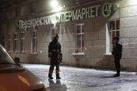 <p>An Emergency Ministry member and a policeman are seen outside a supermarket after an explosion in St. Petersburg, Russia, Dec. 27, 2017. (Photo: Anton Vaganov/Reuters) </p>