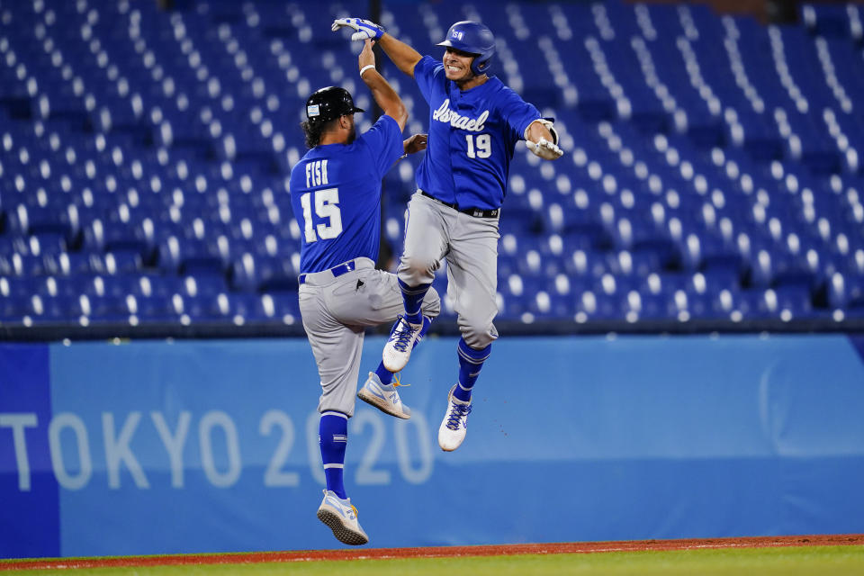 Israel's Danny Valencia celebrates with coach Nate Fish after hitting a two run home run during the eight inning of a baseball game against the Dominican Republicat the 2020 Summer Olympics, Tuesday, Aug. 3, 2021, in Yokohama, Japan. (AP Photo/Matt Slocum)