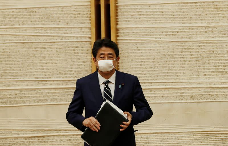 Japan's Prime Minister Shinzo Abe leaves venue after a news conference in Tokyo