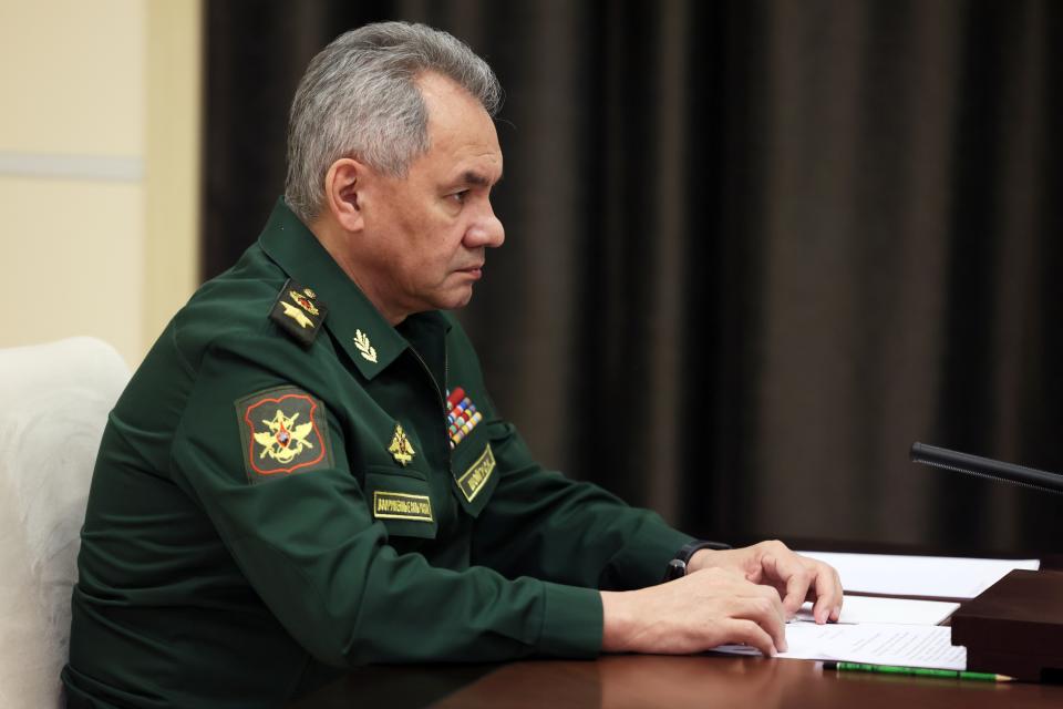 Russian Defense Minister Sergei Shoigu speaks to Russian President Vladimir Putin, right, listens to Russian President Vladimir Putin during their meeting at the Novo-Ogaryovo residence outside Moscow, Russia, Friday, Oct. 28, 2022. (Mikhail Metzel, Sputnik, Kremlin Pool Photo via AP)