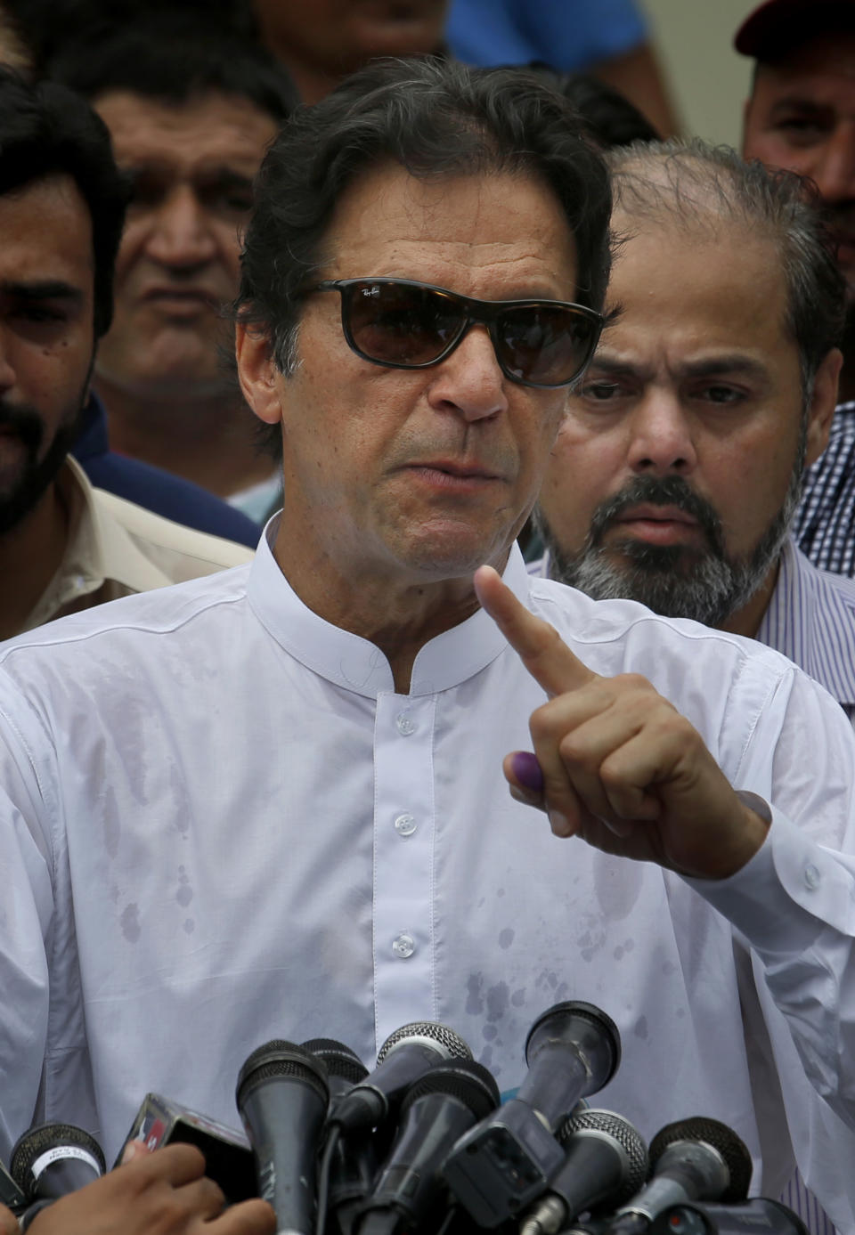 Pakistani politician Imran Khan, chief of Pakistan Tehreek-e-Insaf party, speaks to media after casting his vote at a polling station for the parliamentary elections in Islamabad, Pakistan, Wednesday, July 25, 2018. After an acrimonious campaign, polls opened in Pakistan on Wednesday to elect the country's third straight civilian government, a first for this majority Muslim nation that has been directly or indirectly ruled by its military for most of its 71-year history. (AP Photo/Anjum Naveed)