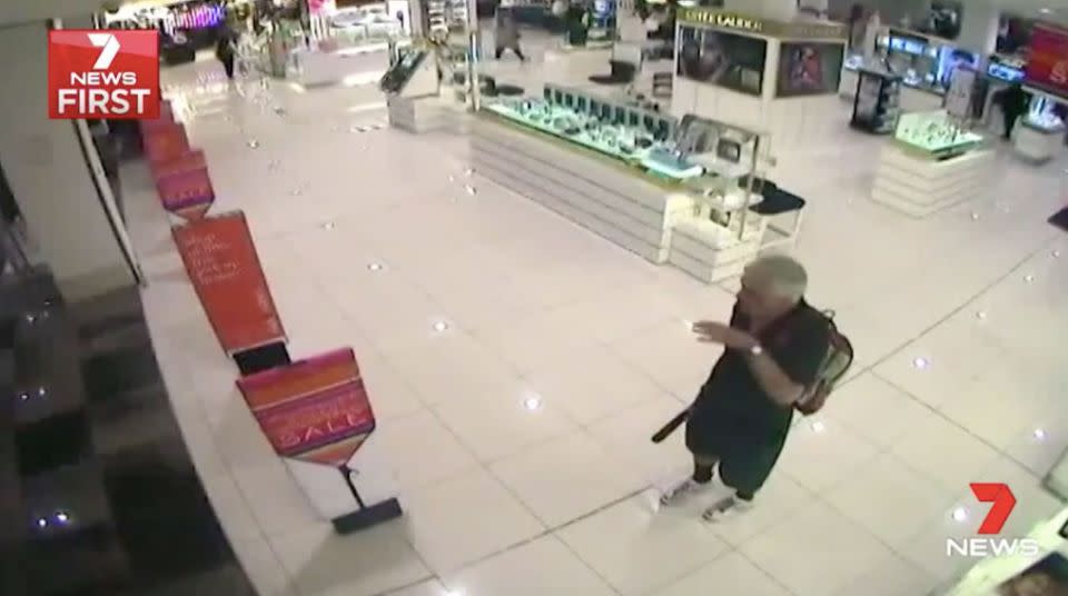 The man can be seen loitering inside Myer with a baseball bat in his hand. Source: 7 News