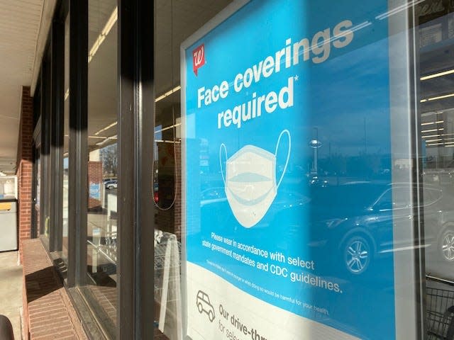 A sign at Walgreens advises customers masks are required in Bartlesville, Okla.