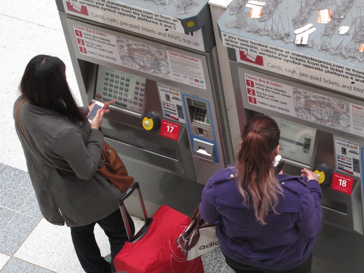 Price sensitive: passengers using ticket machines at a London station (Simon Calder)