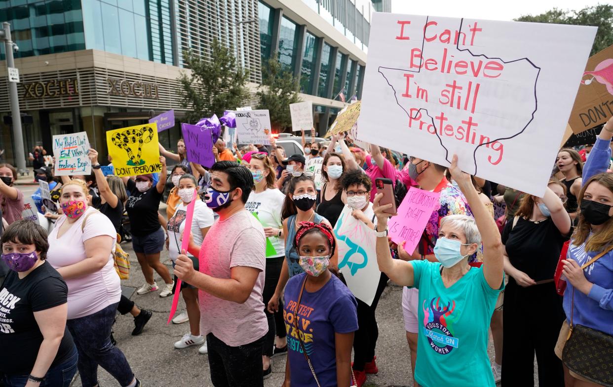 People participate in the Houston Women's March against Texas abortion ban walk from Discovery Green to City Hall in Houston, Texas on Oct. 2, 2021.