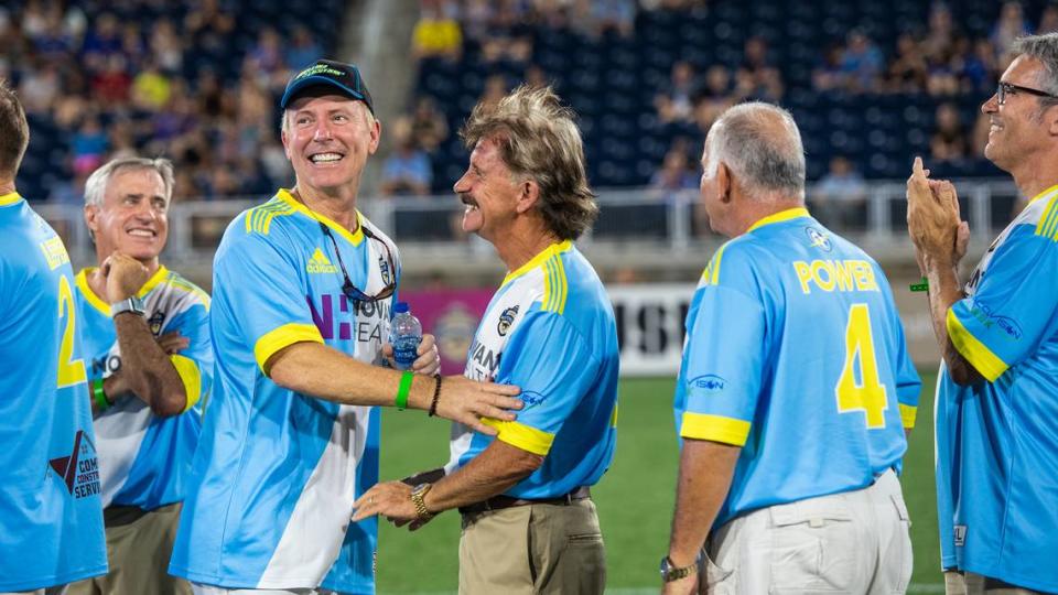 Members of the 1981 championship Carolina Lightnin’ soccer team share smiles as they are introduced to fans during a throwback night at American Legion Memorial Stadium on Saturday, September 18, 2021 in Charlotte, NC to celebrate the 40th anniversary of the team’s title. From left to right: Greg Heileman, David Pierce, Don Tobin, Dave Power (4) and Steve Scott.