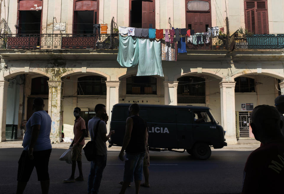 A police vehicle patrols through Old Havana, Cuba, Monday, July 12, 2021, the day after protests against food shortages and high prices amid the coronavirus crisis. (AP Photo/Eliana Aponte)