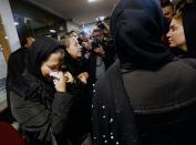 <p>Unidentified relatives of sailors who were onboard ‘Sanchi’ oil tanker that sunk off the coast of China mourn inside the Iranian company in Tehran, Iran, Jan. 14, 2018. (Photo: EFE/EPA/Abedin Taherkenareh) </p>