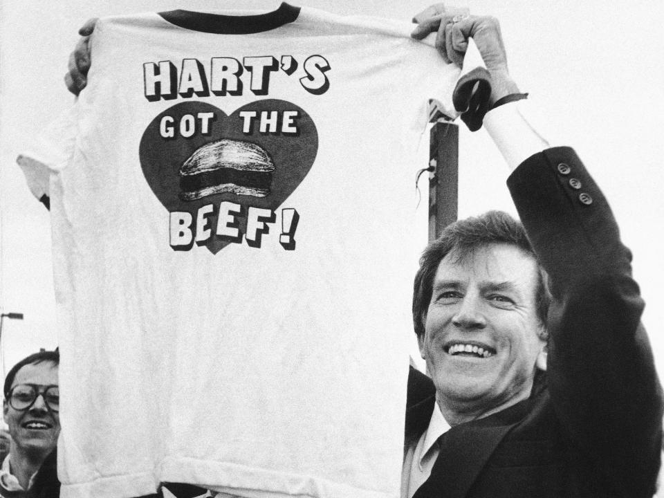 1984 Democratic presidential candidate Gary Hart holds up a shirt that says 'Hart's got the beef!', a parody on a popular Wendy's commercial of the era that his opponent Walter Mondale was using to criticize his experience.