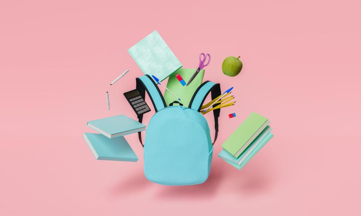 school supplies floating with blue backpack and red pastel background