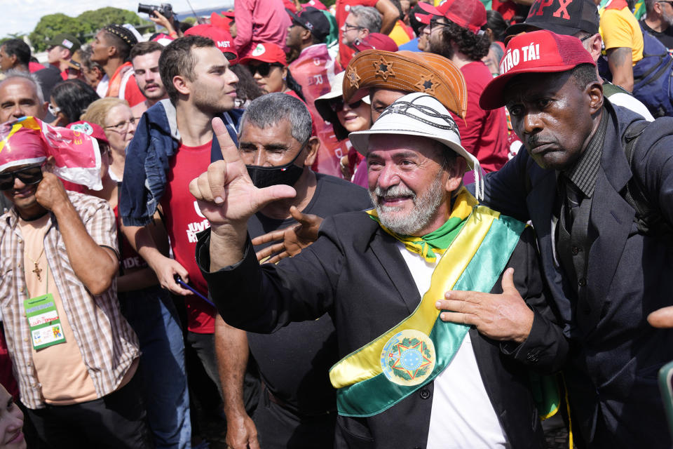 Supporters of Luiz Inacio Lula da Silva gathering to attend his inauguration as new president outside the Planalto presidential palace in Brasilia, Brazil, Sunday, Jan. 1, 2023. (AP Photo/Silvia Izquierdo)