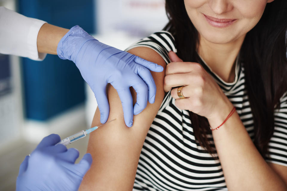 Woman receiving an injection in her arm