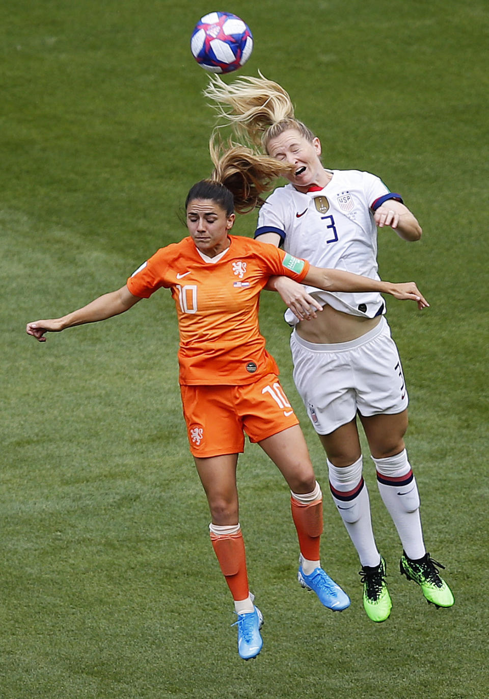 Netherlands' Danielle Van De Donk, left, and United States' Samantha Mewis challenge for the ball during the Women's World Cup final soccer match between US and The Netherlands at the Stade de Lyon in Decines, outside Lyon, France, Sunday, July 7, 2019. (AP Photo/Francois Mori)