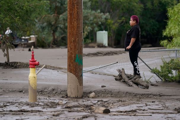 PHOTO: Perla Halbert gets a look at the damage to her property, unable to access it due to deep mud in her driveway, in the aftermath of a mudslide, Sept. 13, 2022, in Oak Glen, Calif. (Marcio Jose Sanchez/AP)