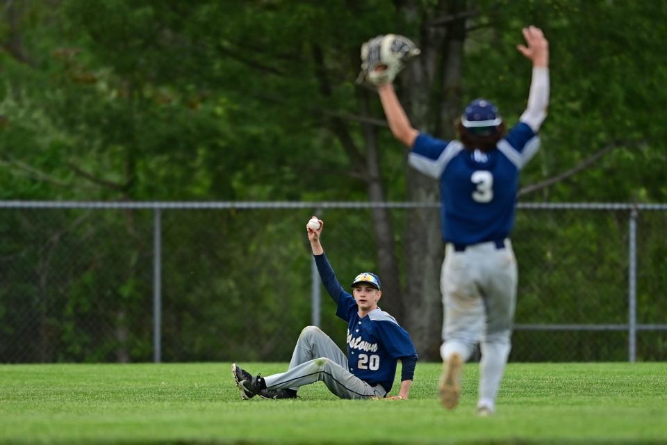 Rootstown's Joe Weaver, left, shows the ball to the umpire after making a diving catch in the fourth inning of their district semifinal against Cardinal Mooney at Cene Park in Struthers.