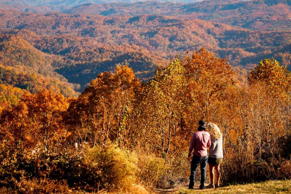 Caleb Dennis, of High Point, N.C., and Renita Matson, of Asheboro, N.C., take inthe Fall foliage from Grandview Overlook along the Blue Ridge Parkway in Boone, N.C., Monday, Oct. 24, 2022.