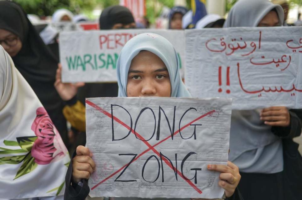 Protesters hold placards as they staged a peaceful protest in Kuala Lumpur January 1, 2020. ― Picture by Shafwan Zaidon