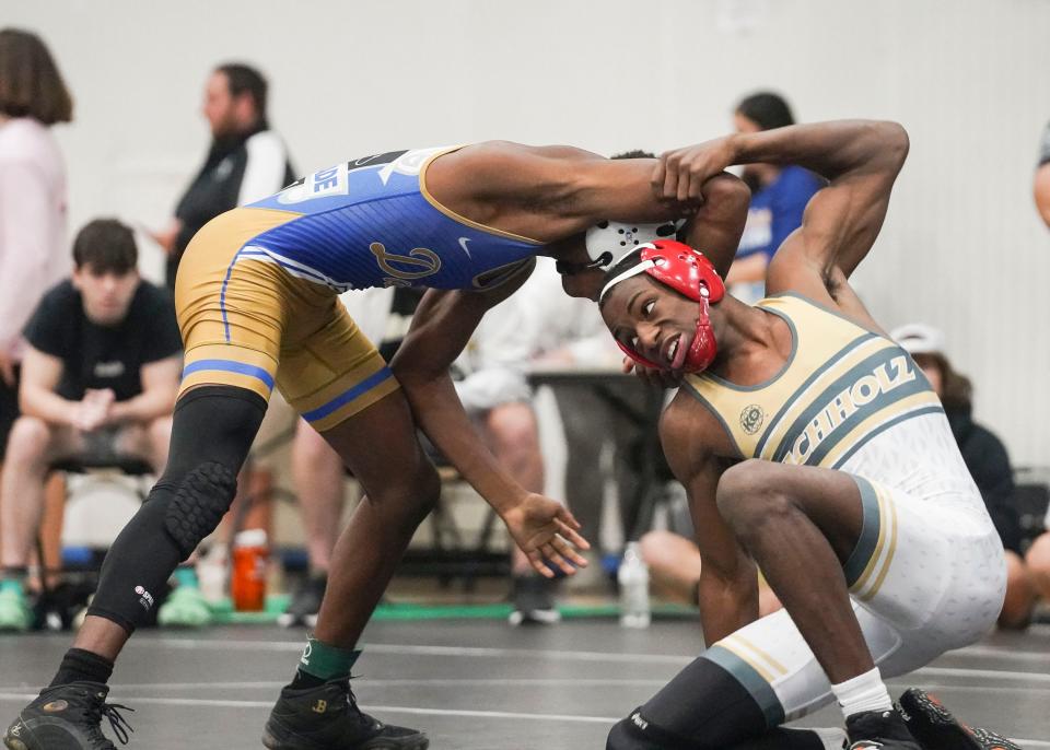 Buchholz's Cavarius Liddie (right) wrestles South Dade's Tyree Graham in the 132 pound match during the Cradle Cancer Invitational wrestling tournament on Saturday, Jan. 7, 2023, at Jensen Beach High School. 