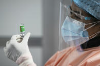 A Nepalese health worker prepares to administer a COVID-19 vaccine to a hospital staff at Teaching Hospital in Kathmandu, Nepal, Wednesday, Jan. 27, 2021. Thousands of health workers lined up across Nepal to get the coronavirus vaccine Wednesday as the Himalayan nation began its campaign to get the population vaccinated within three months. Neighboring India gifted Nepal 1 million doses of the AstraZeneca-Oxford University vaccine manufactured under license by the Serum Institute of India. (AP Photo/Niranjan Shrestha)