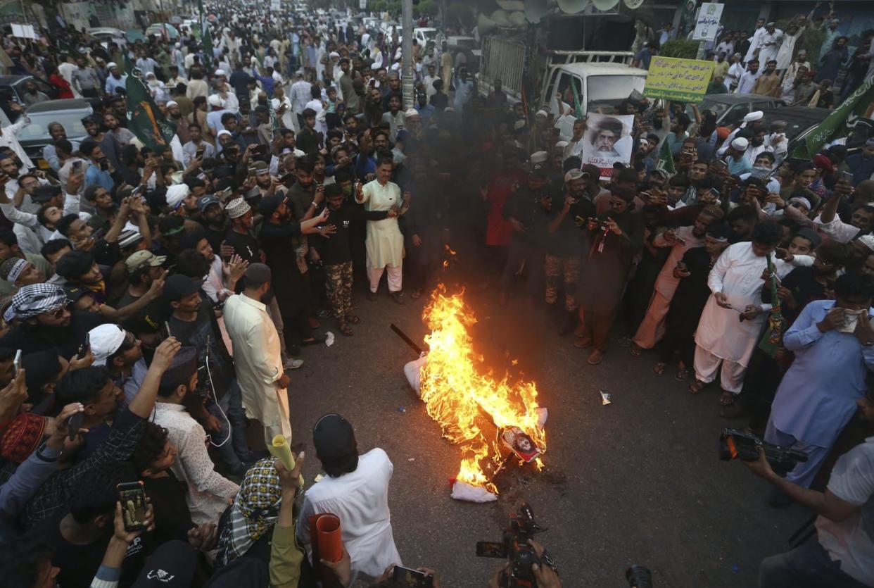 <span class="caption">Supporters of a Pakistani religious group burn an effigy depicting the former spokeswoman of India's ruling party, Nupur Sharma, during a demonstration in Karachi, Pakistan.</span> <span class="attribution"><a class="link " href="https://newsroom.ap.org/detail/PakistanIndiaIslam/cfcff703192e4cfda0ddc017f7060ad8/photo?Query=nupur%20sharma&mediaType=photo&sortBy=&dateRange=Anytime&totalCount=65&currentItemNo=0" rel="nofollow noopener" target="_blank" data-ylk="slk:AP Photo/Fareed Khan;elm:context_link;itc:0;sec:content-canvas">AP Photo/Fareed Khan</a></span>