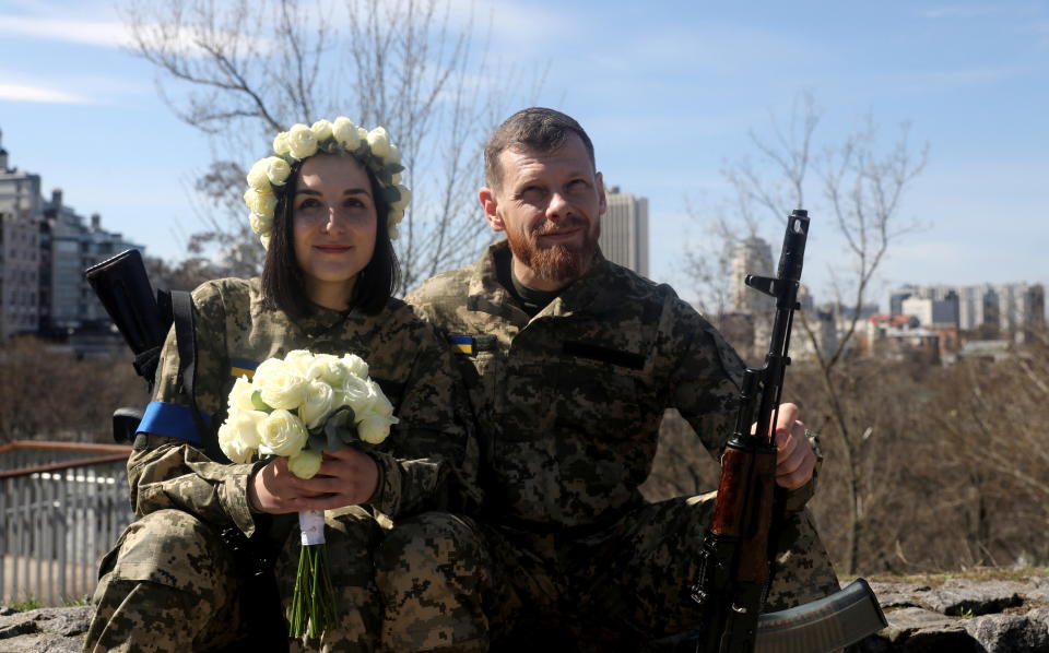 Members of the Ukrainian Territorial Defence Forces Anastasiia (24) and Viacheslav (43) wait to attend their wedding ceremony, amid Russia's invasion of Ukraine, in Kyiv, Ukraine, April 7, 2022. REUTERS/Mykola Tymchenko