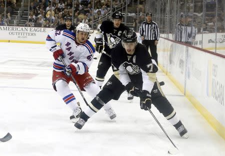 May 9, 2014; Pittsburgh, PA, USA; Pittsburgh Penguins center Evgeni Malkin (71) handles the puck as New York Rangers left wing Carl Hagelin (62) chases during the second period in game five of the second round of the 2014 Stanley Cup Playoffs at the CONSOL Energy Center. The Rangers won 5-1. Mandatory Credit: Charles LeClaire-USA TODAY Sports