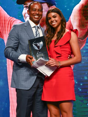 <p>Chris Condon/PGA TOUR/Getty </p> Tiger Woods and Sam Woods on stage during the World Golf Hall of Fame Induction Ceremony on March 9, 2022 in Ponte Vedra Beach, Florida.