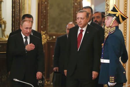 Russian President Vladimir Putin (L) shows the way to his Turkish counterpart Tayyip Erdogan (2nd R) during a meeting at the Kremlin in Moscow, Russia, March 10, 2017. REUTERS/Sergei Ilnitsky/Pool