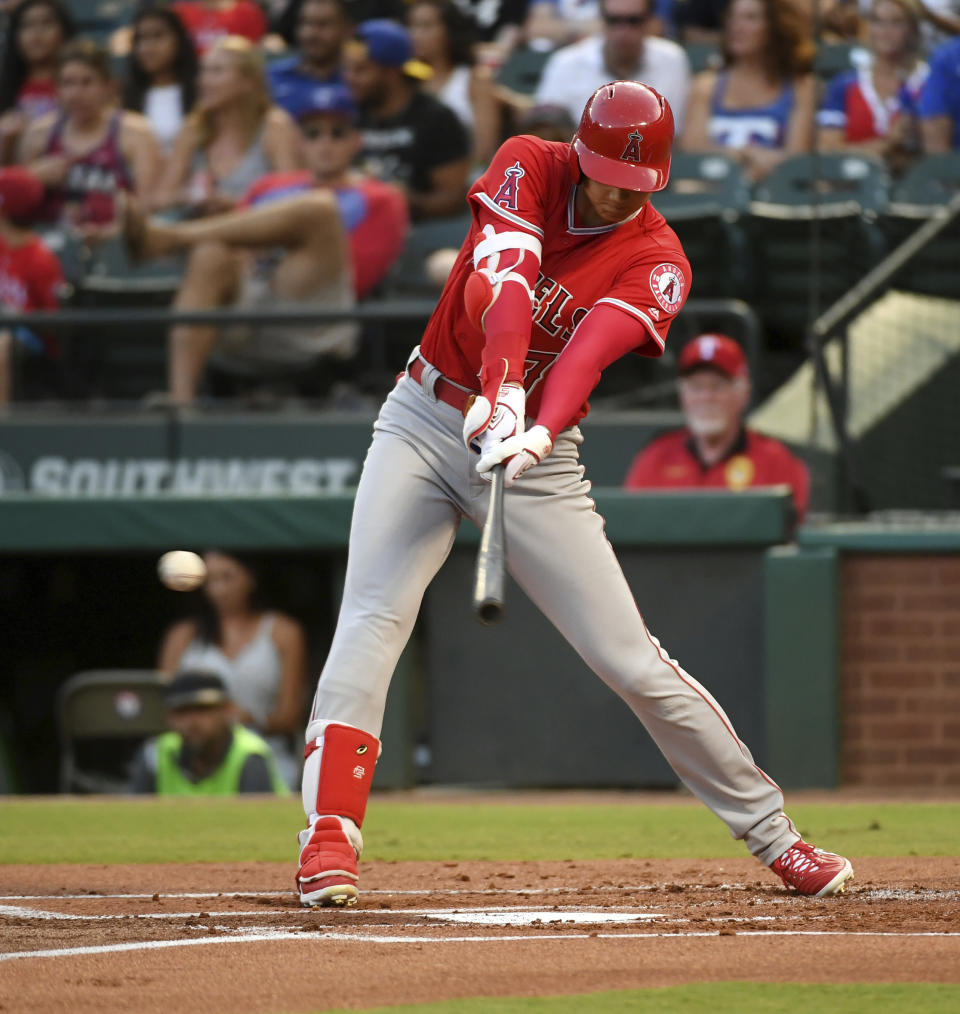 Los Angeles Angels designated hitter Shohei Ohtani connects on an RBI single off Texas Rangers starting pitcher Ariel Jurado during the first inning of a baseball game, Thursday, Aug. 16, 2018, in Arlington, Texas. (AP Photo/Jeffrey McWhorter)