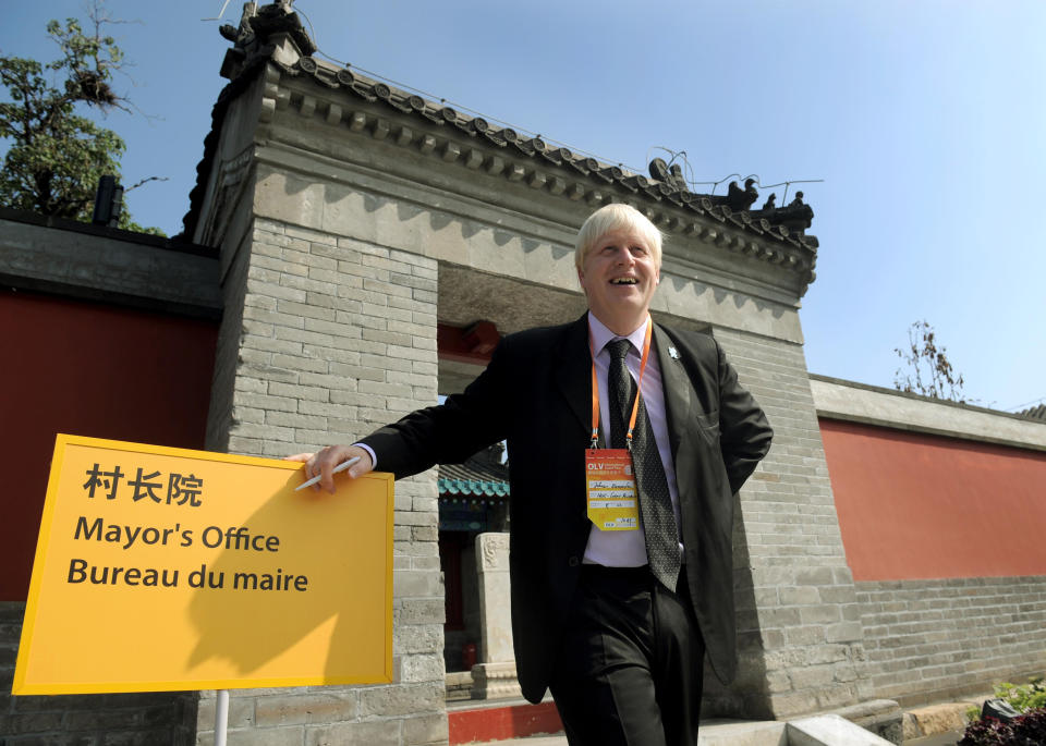 London Mayor Boris Johnson stand next to an appropriate sign during a visit to the athletes' village in Beijing where he is attending the last few days of the 2008 Olympic Games, and participating in the London Handover during the closing ceremony on Sunday.