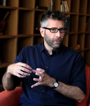 U.S. photographer Brian McCarty gestures as he speaks during an interview with Reuters in Beirut, Lebanon June 9, 2018. REUTERS/Jamal Saidi