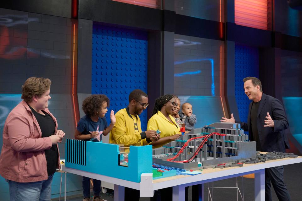 Host Will Arnett with contestants Paul Wellington and Nealita Nelson in the season finale of "Lego Masters," which airs Dec. 14.